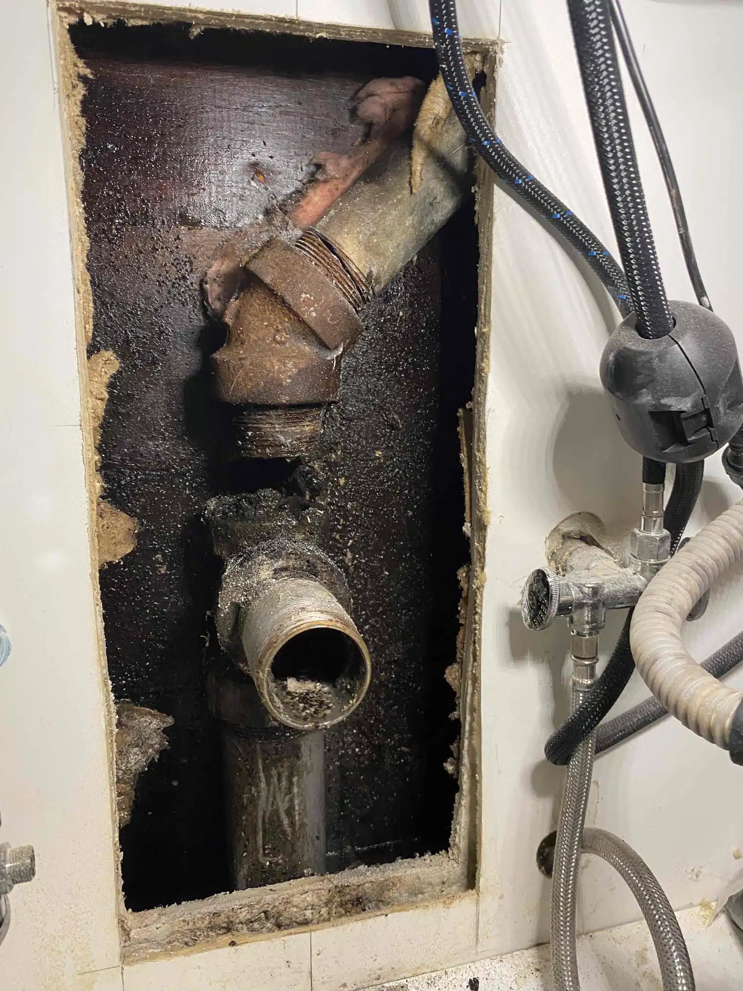 Drain Line Before Repair in Durham, CA Damaged drain line inside wall before repair in Durham, CA