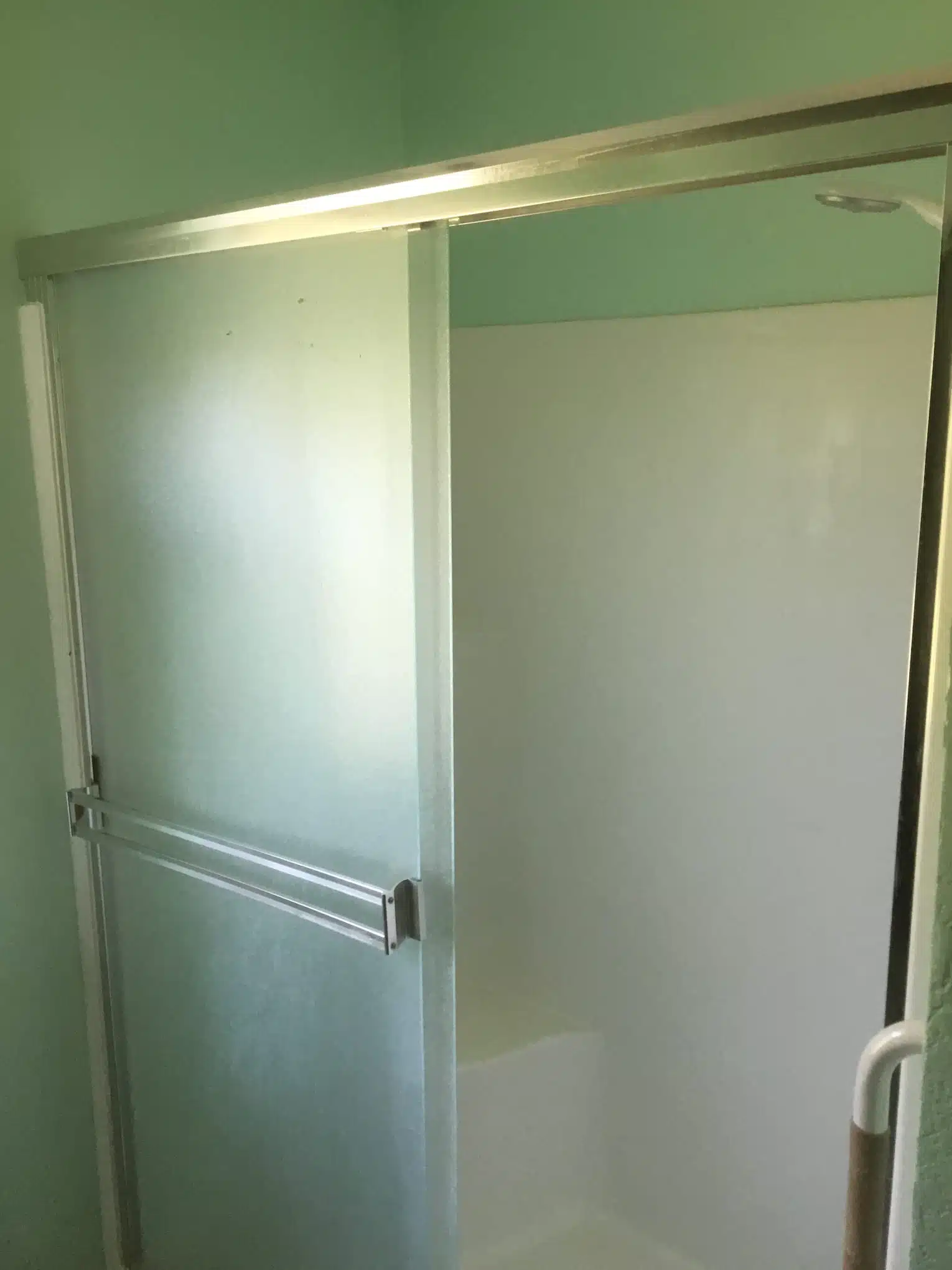 Hard Water Buildup on Shower Door Hard water buildup on a glass shower door