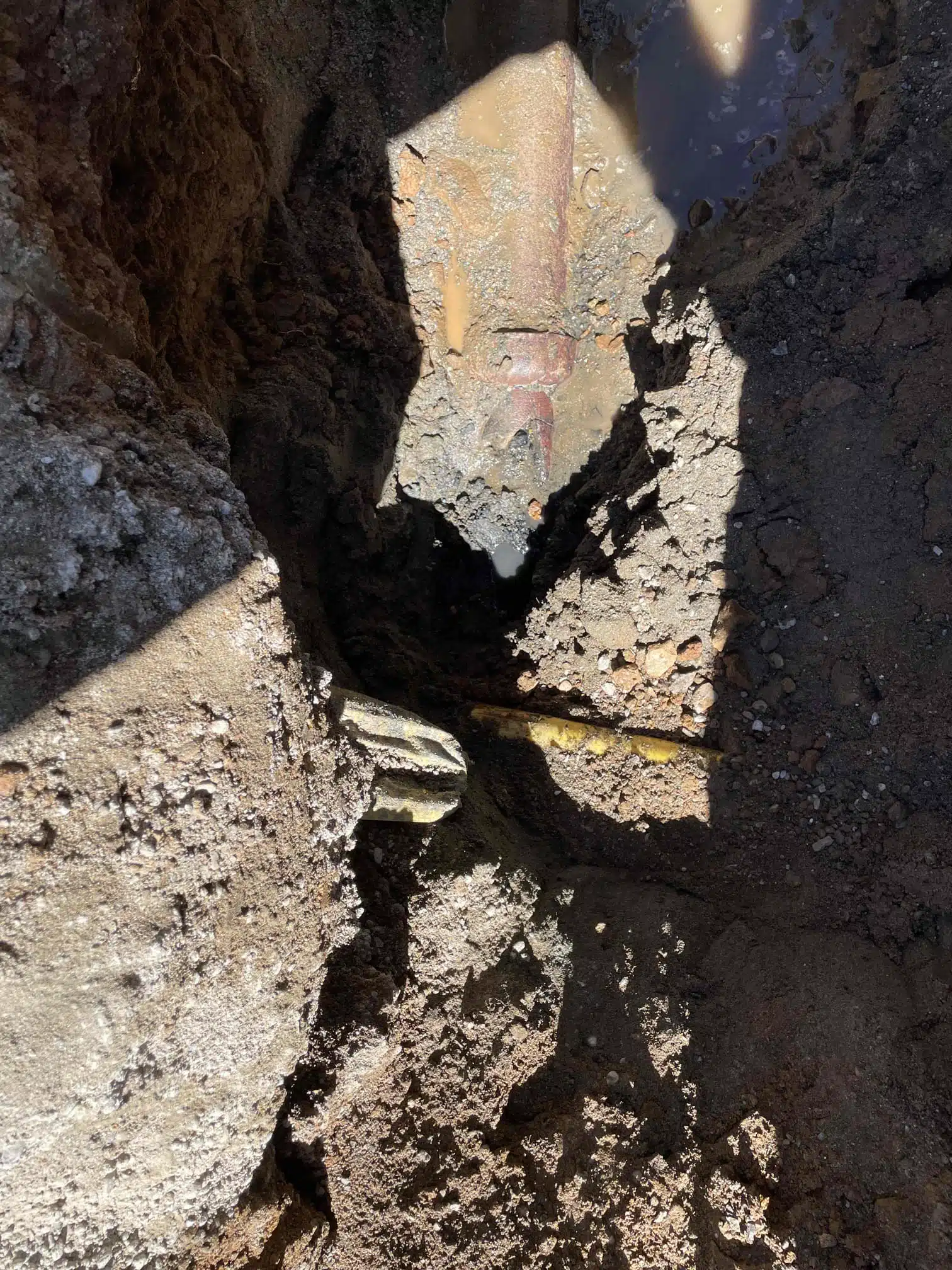 Broken Clay Sewer Pipe Before Replacement Broken clay sewer pipe exposed before sewer line replacement