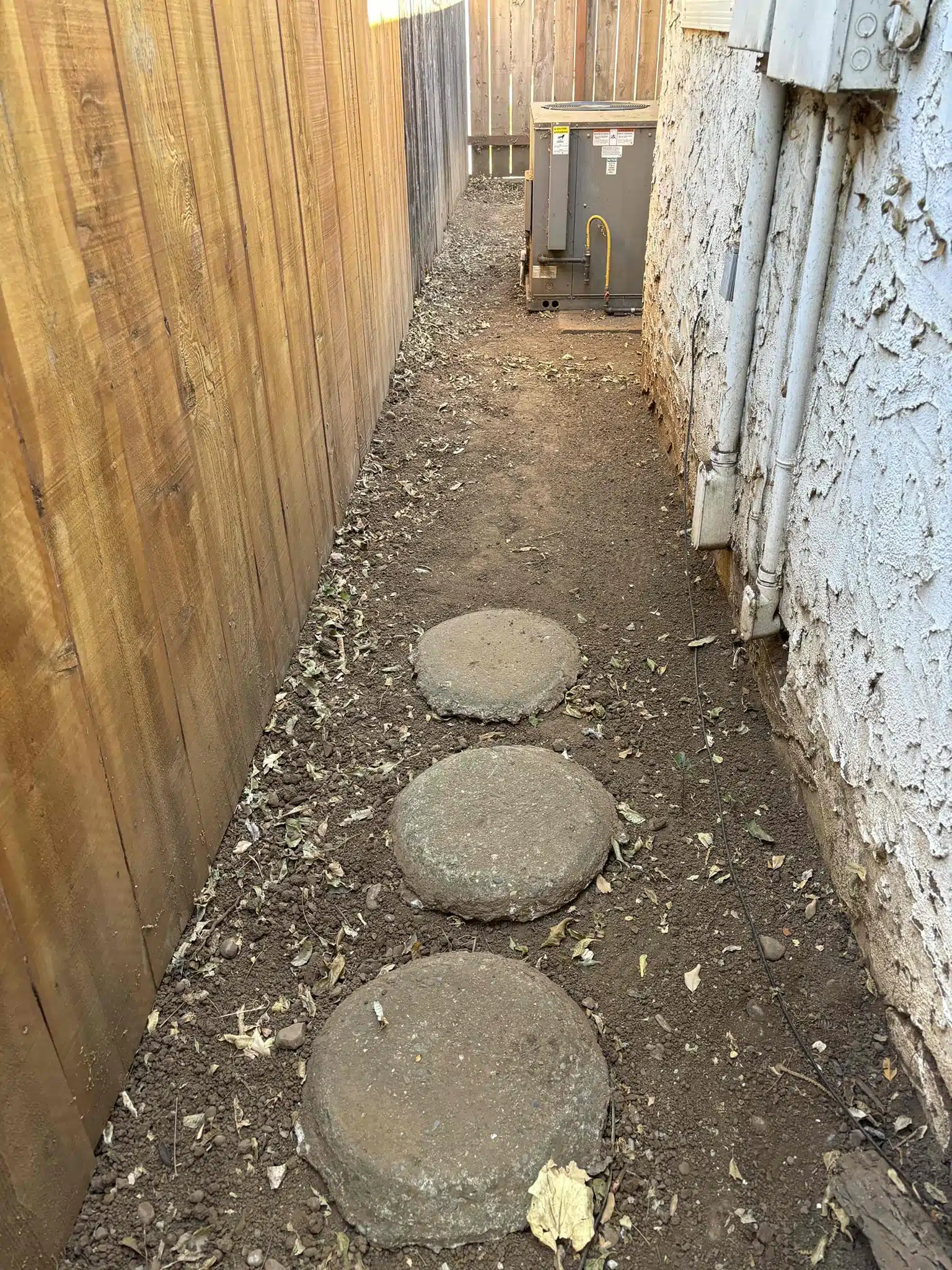 Side Yard After Water Line Replacement Side yard restored with pavers after water line replacement