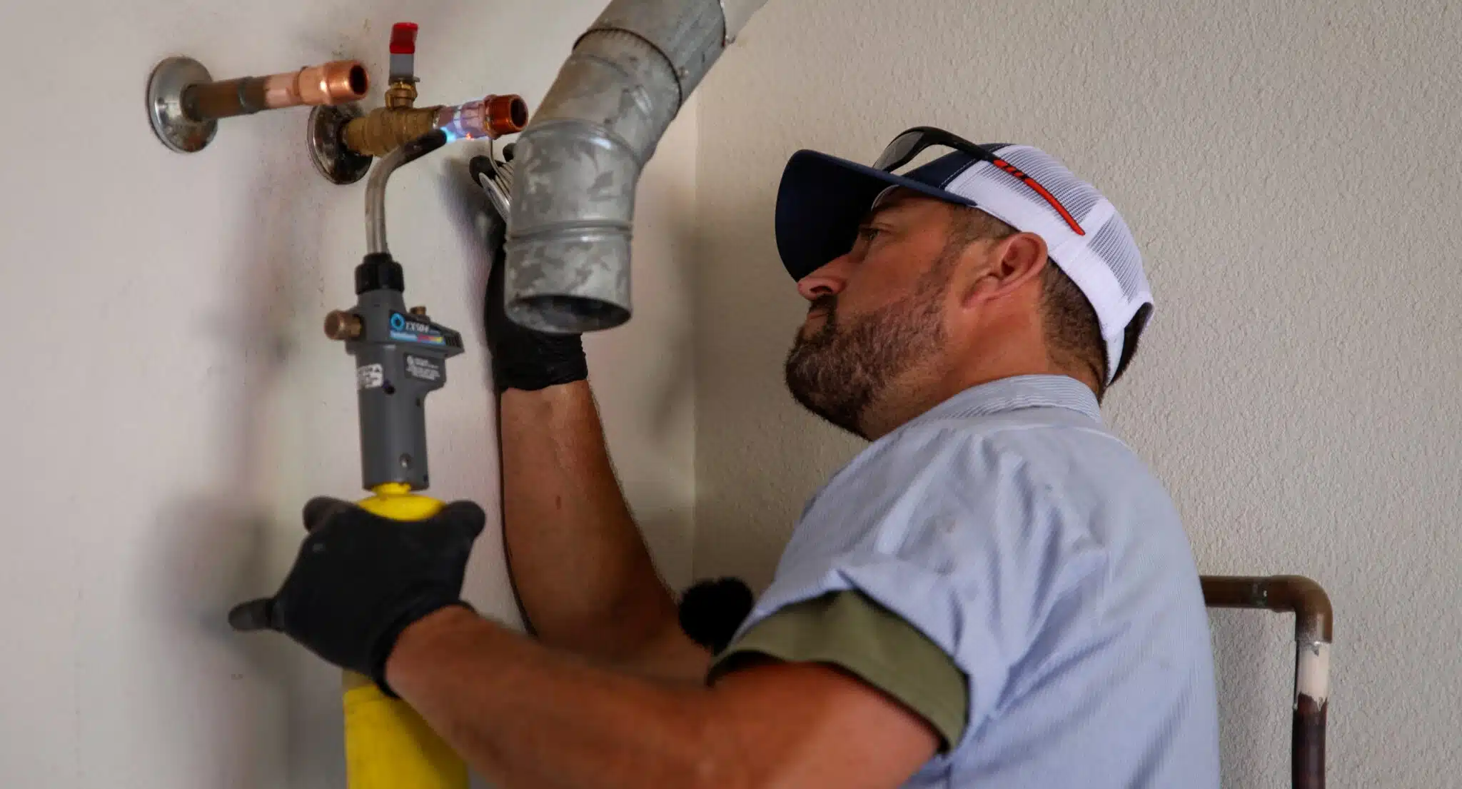 Earl's Plumbing technician making new water heater connections